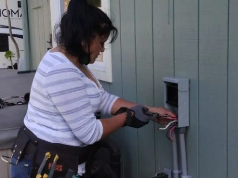 Licensed electrician wiring an exterior subpanel in Lake